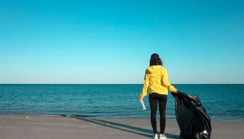 image of woman cleaning trash
